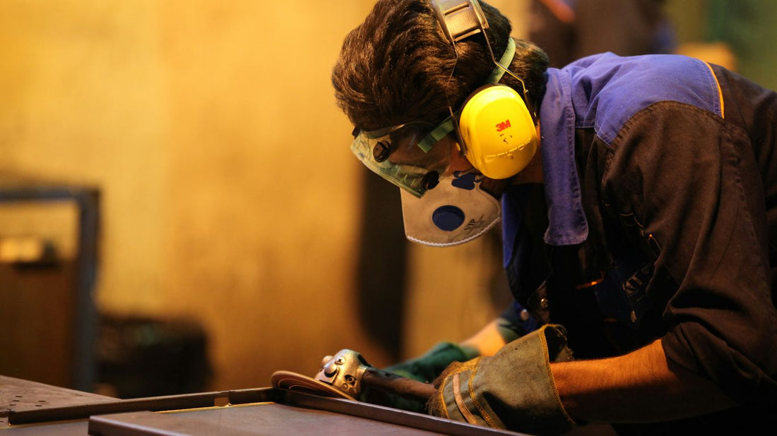 man in blue denim jacket wearing yellow helmet