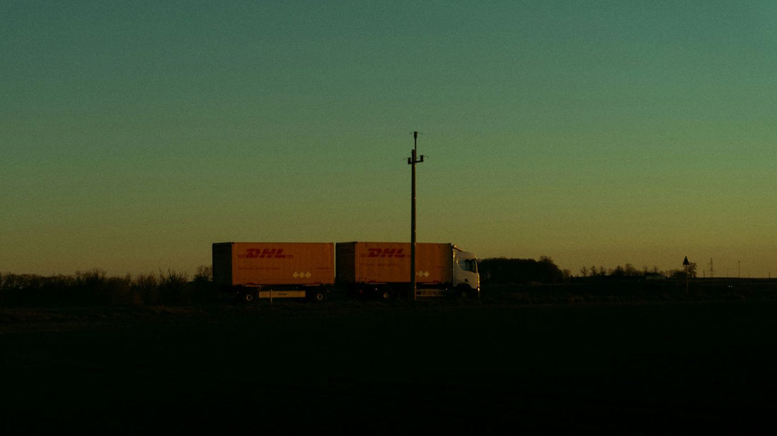 Semi-truck silhouetted against a twilight sky.