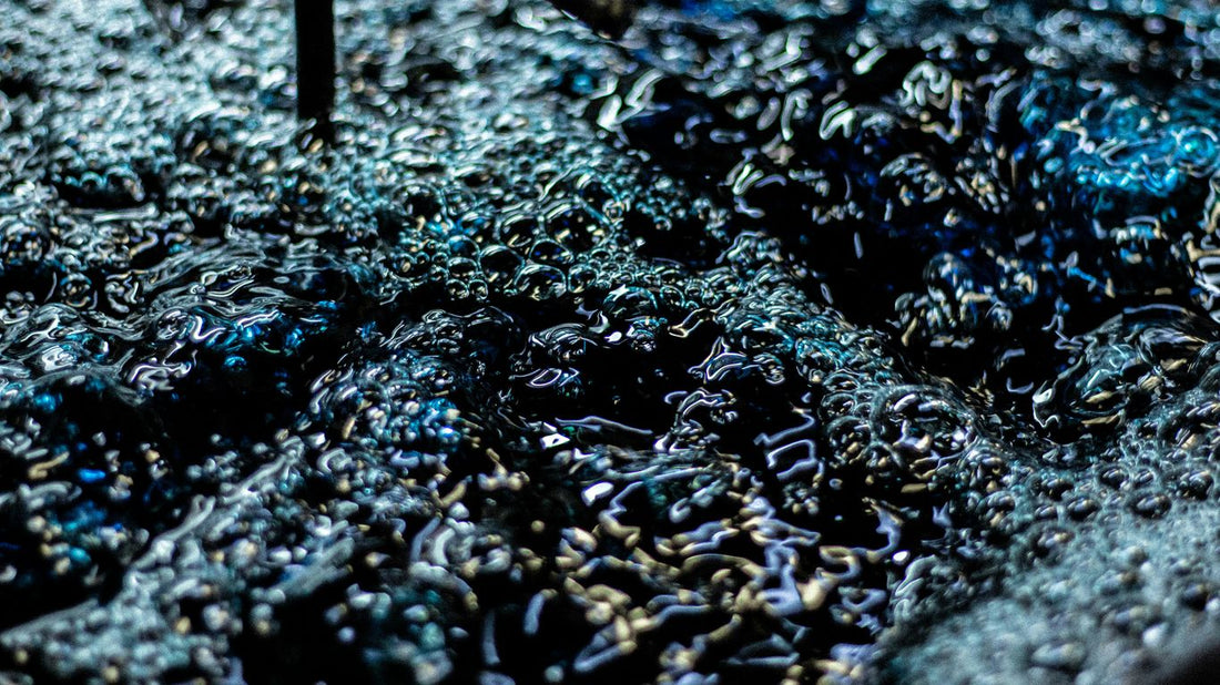 Close-up of dark blue liquid with bubbles.