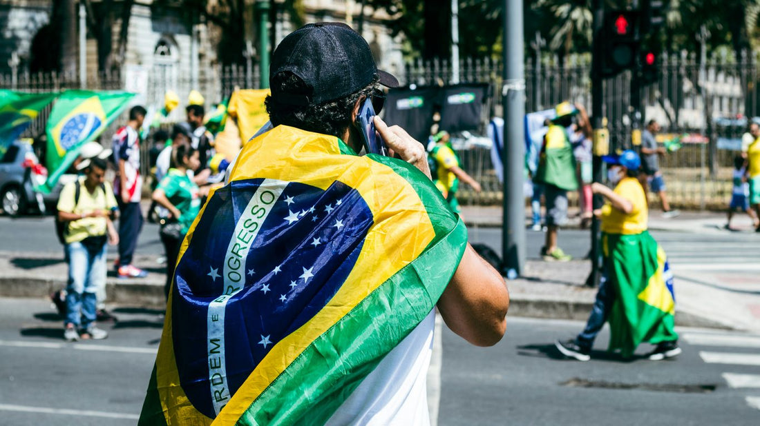 a man with a flag on his back walking down the street